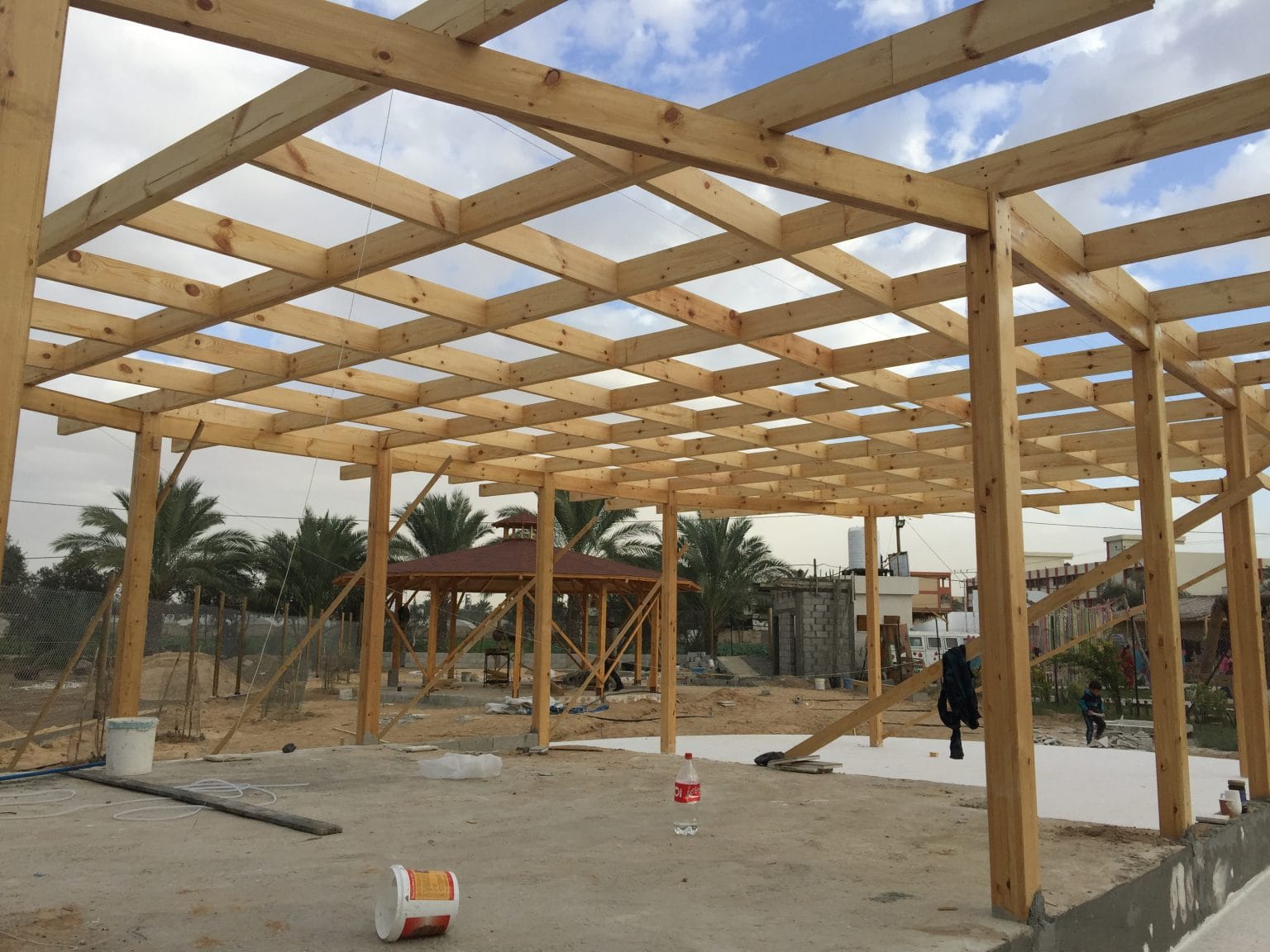 Veranda Design team building a shaded community structure in Gaza